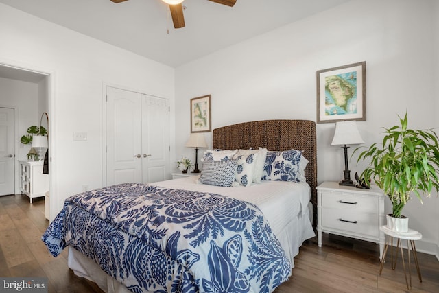 bedroom featuring a closet, wood finished floors, and a ceiling fan