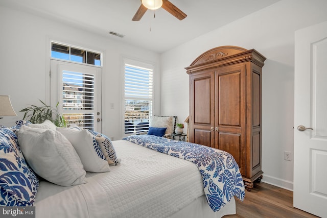 bedroom featuring visible vents, ceiling fan, baseboards, dark wood-style floors, and access to outside