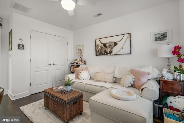 living area with a ceiling fan, wood finished floors, and visible vents