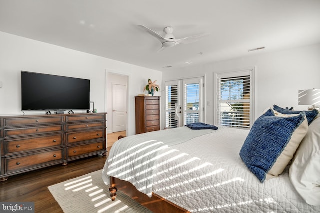 bedroom featuring ceiling fan, visible vents, dark wood-type flooring, and access to exterior