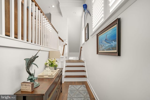 staircase featuring recessed lighting, wood finished floors, and baseboards