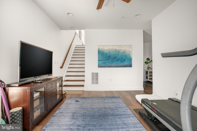 interior space with visible vents, a ceiling fan, wood finished floors, recessed lighting, and stairs