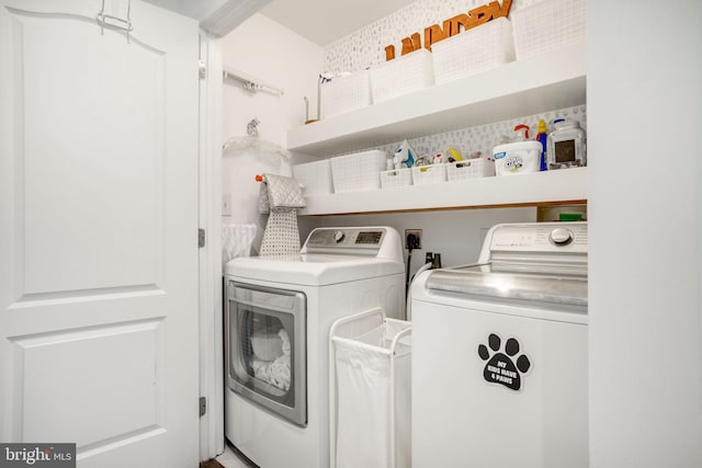 clothes washing area featuring washer and clothes dryer and laundry area