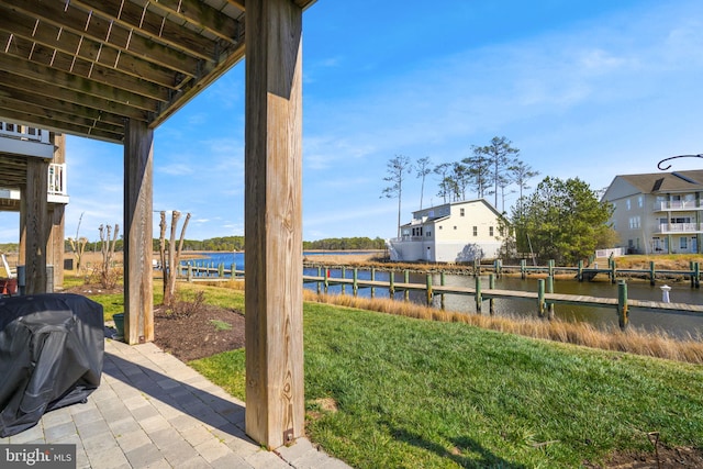 view of patio / terrace with a water view and a grill