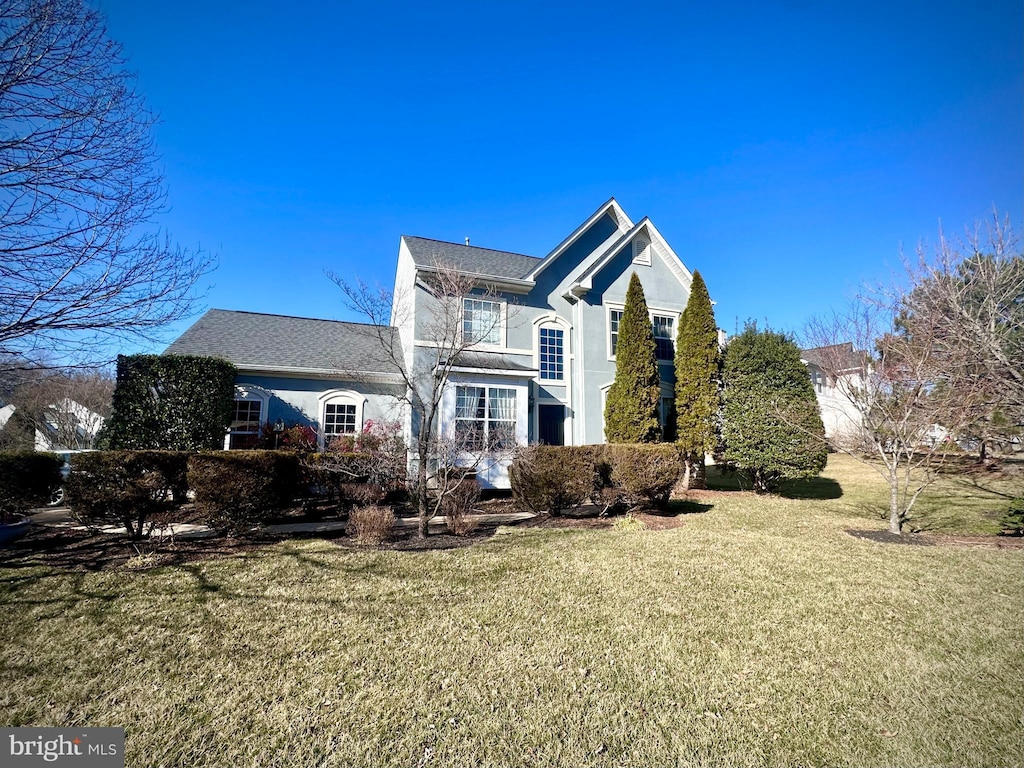 exterior space featuring a lawn and stucco siding