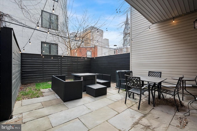 view of patio featuring outdoor dining area, a fenced backyard, and outdoor lounge area