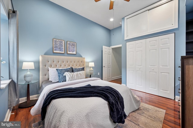 bedroom featuring ceiling fan, wood finished floors, a closet, and baseboards