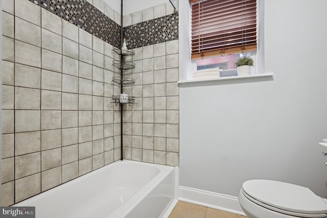 full bath featuring tile patterned floors, baseboards, toilet, and tub / shower combination