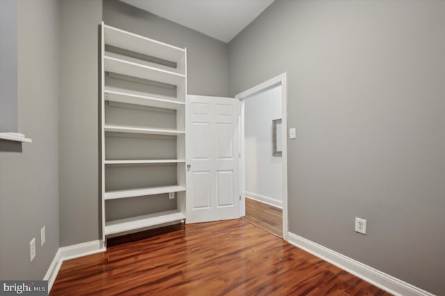 interior space with a closet, baseboards, and wood finished floors