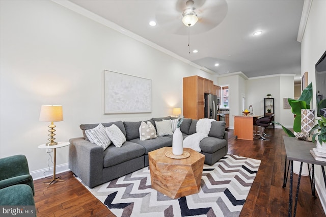 living room featuring dark wood-style floors, baseboards, and ornamental molding