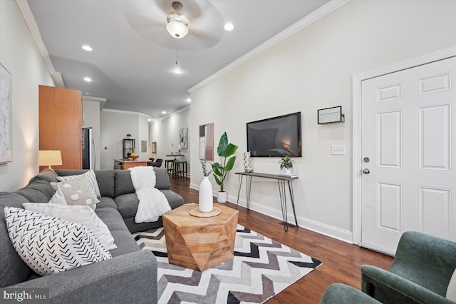 living room with ornamental molding, wood finished floors, recessed lighting, baseboards, and ceiling fan