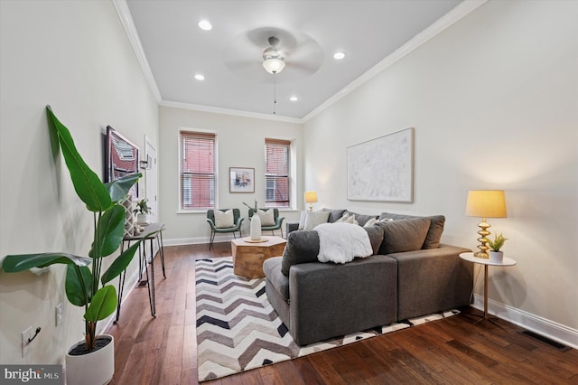 living room featuring visible vents, ornamental molding, dark wood-style floors, baseboards, and ceiling fan