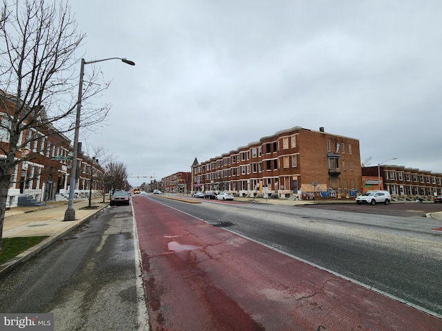 view of street with curbs, sidewalks, and street lighting