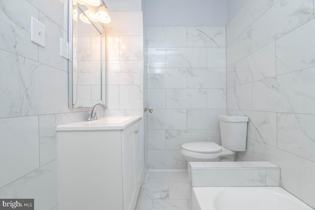 bathroom featuring vanity, a bathing tub, tile walls, toilet, and marble finish floor