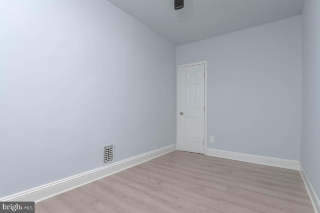 spare room featuring ceiling fan, baseboards, visible vents, and light wood-type flooring