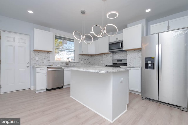 kitchen with white cabinetry, decorative backsplash, and stainless steel appliances