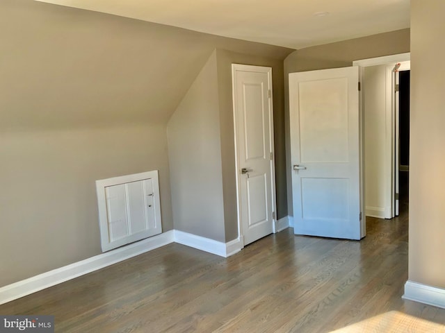 additional living space featuring vaulted ceiling, wood finished floors, and baseboards