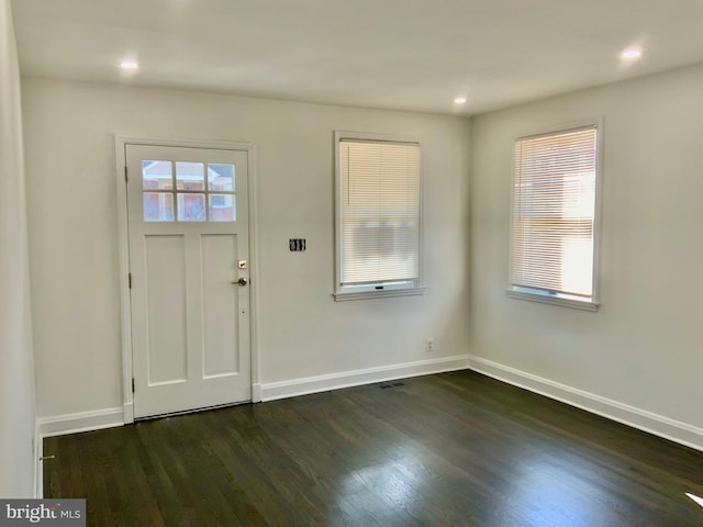 entryway with dark wood-style floors, visible vents, recessed lighting, and baseboards