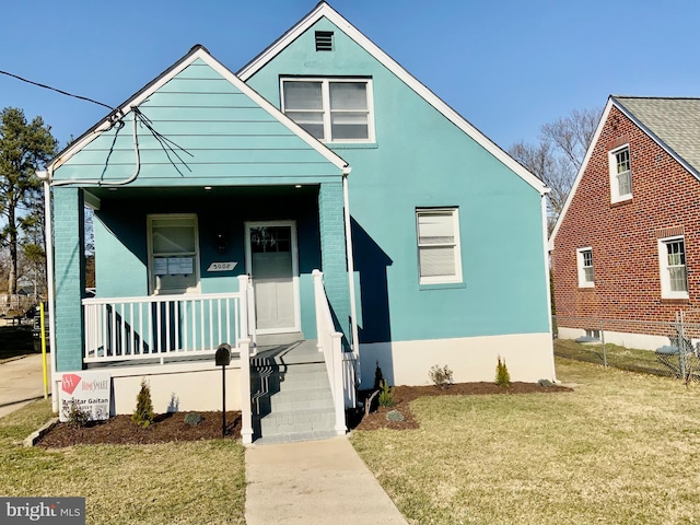 bungalow-style home featuring a porch and a front lawn