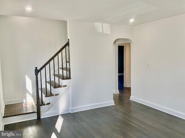 stairs featuring recessed lighting, baseboards, arched walkways, and wood finished floors