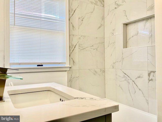 bathroom featuring a wealth of natural light and a sink