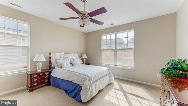 bedroom featuring visible vents, baseboards, and light colored carpet