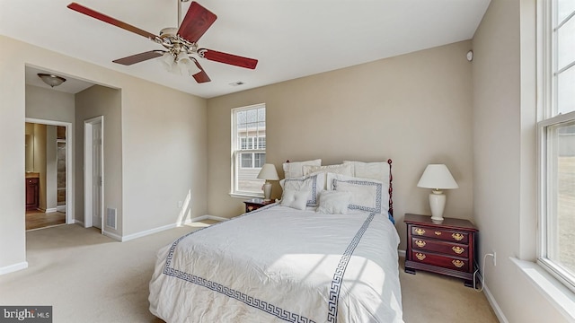 bedroom with light colored carpet, visible vents, and baseboards