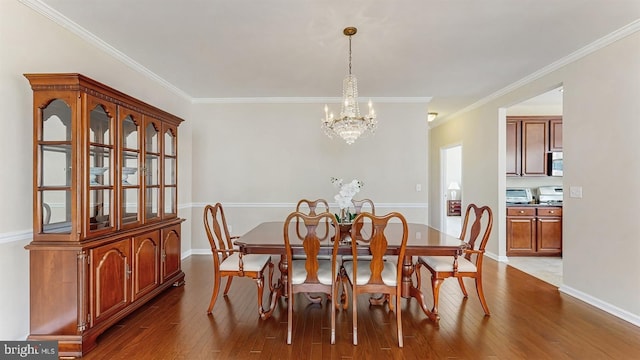 dining area featuring a notable chandelier, crown molding, baseboards, and dark wood-style flooring