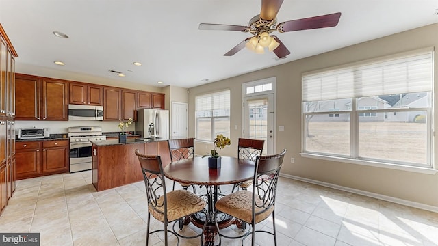 dining room with recessed lighting, light tile patterned floors, a ceiling fan, and baseboards