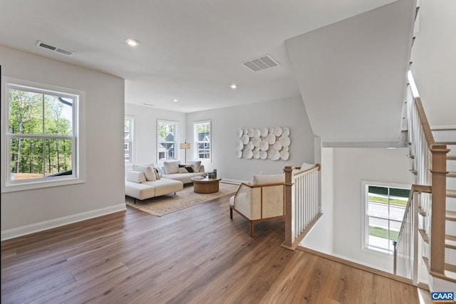 living area featuring recessed lighting, visible vents, and hardwood / wood-style flooring