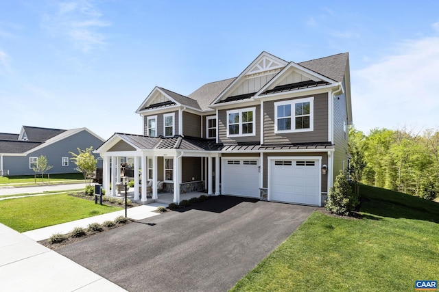 view of front of property with a standing seam roof, covered porch, aphalt driveway, board and batten siding, and metal roof