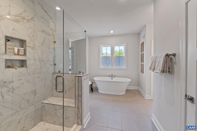 full bath with recessed lighting, a shower stall, tile patterned flooring, baseboards, and a soaking tub