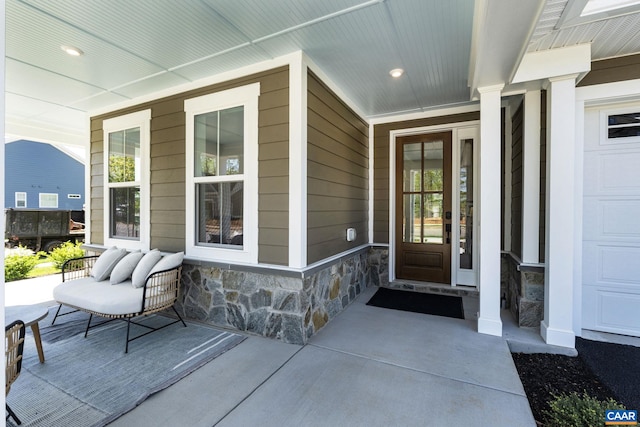 entrance to property featuring stone siding and covered porch