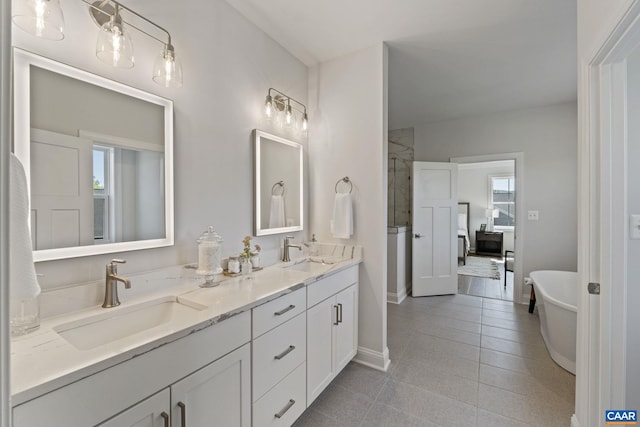 full bathroom featuring double vanity, a freestanding tub, a shower with door, and a sink