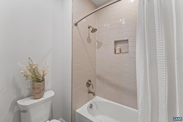 bathroom with shower / bath combo with shower curtain and toilet