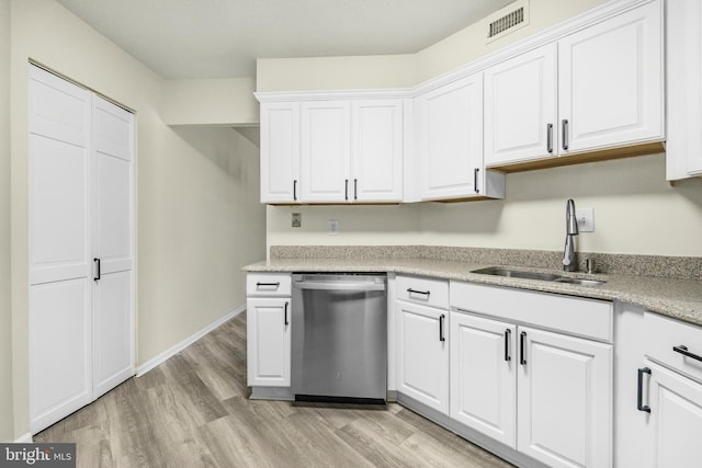 kitchen featuring stainless steel dishwasher, light wood-style floors, white cabinetry, and a sink