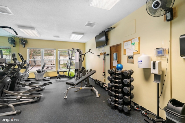 exercise room featuring visible vents and a textured ceiling