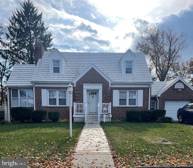 cape cod house with brick siding, a chimney, and a front yard