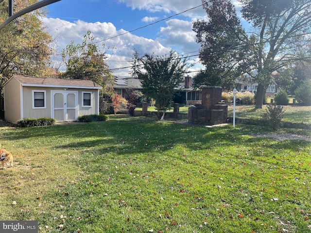 view of yard with an outbuilding and a storage shed