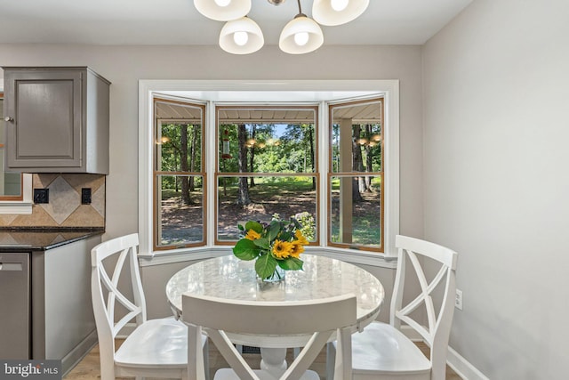 dining area with baseboards and a chandelier