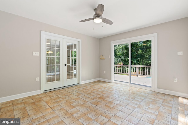 empty room with ceiling fan, french doors, and baseboards