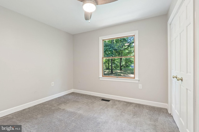 unfurnished bedroom with carpet flooring, baseboards, visible vents, and a closet