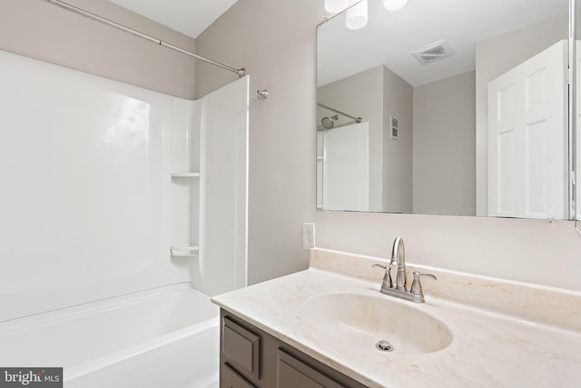 full bath with visible vents, vanity, and shower / bathtub combination