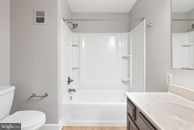 bathroom featuring bathtub / shower combination, toilet, vanity, and visible vents