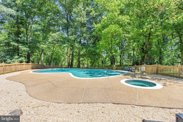 view of pool featuring a fenced in pool, a patio, an in ground hot tub, and a fenced backyard