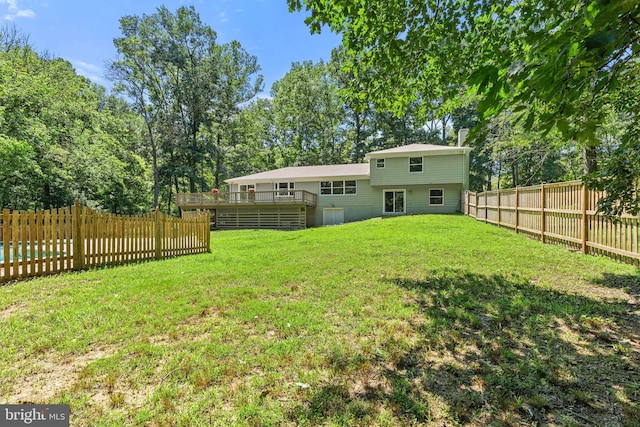 view of yard with a fenced backyard and a wooden deck