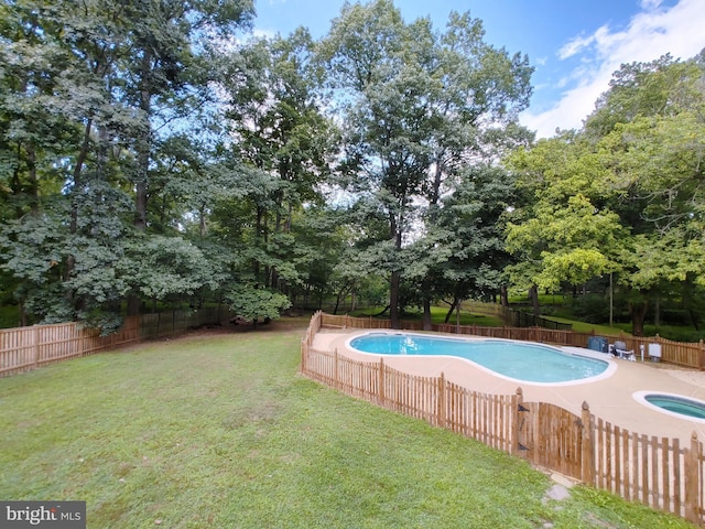 view of pool with a fenced in pool, a lawn, and a fenced backyard