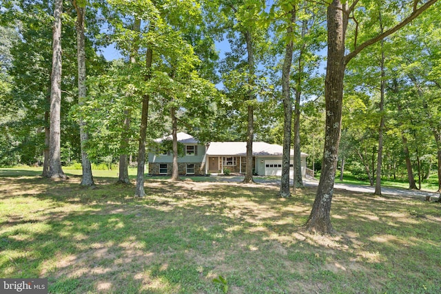 view of front of home featuring a garage and a front lawn