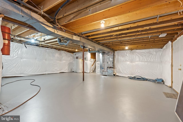 unfinished basement featuring heating unit and water heater