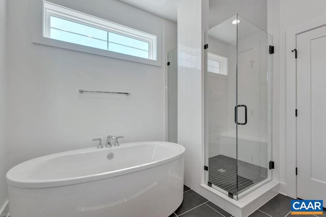 full bath with a soaking tub, a stall shower, and tile patterned flooring